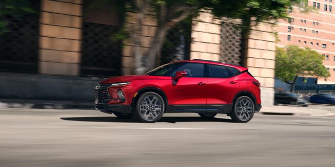 Left profile view of the 2023 Chevrolet Blazer driving on the road.