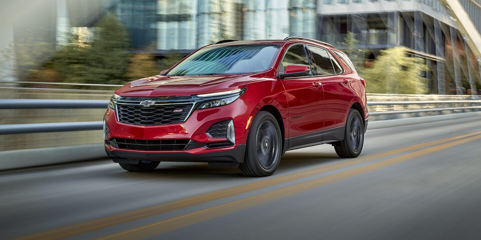 The 2023 Chevrolet Equinox driving on the road.