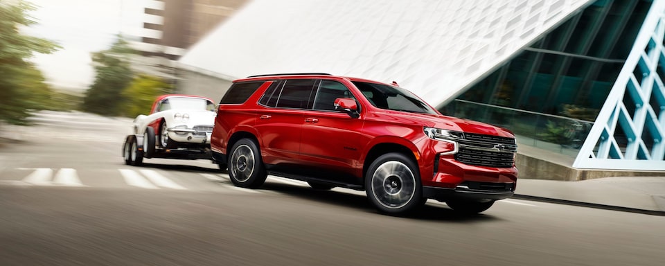 2023 Chevrolet Tahoe towing a smaller vehicle.