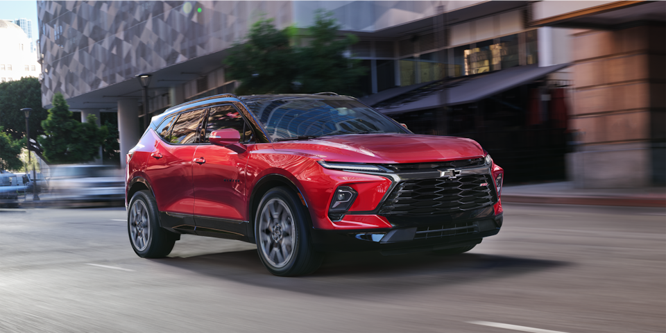 Front side view of a 2024 Chevrolet Blazer sporty mid-size SUV driving on the road.