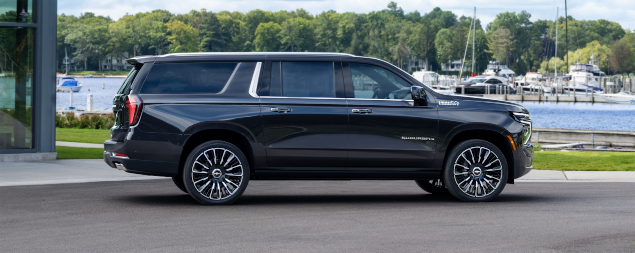 Side View of the 2025 Chevrolet Suburban Parked near the docks.