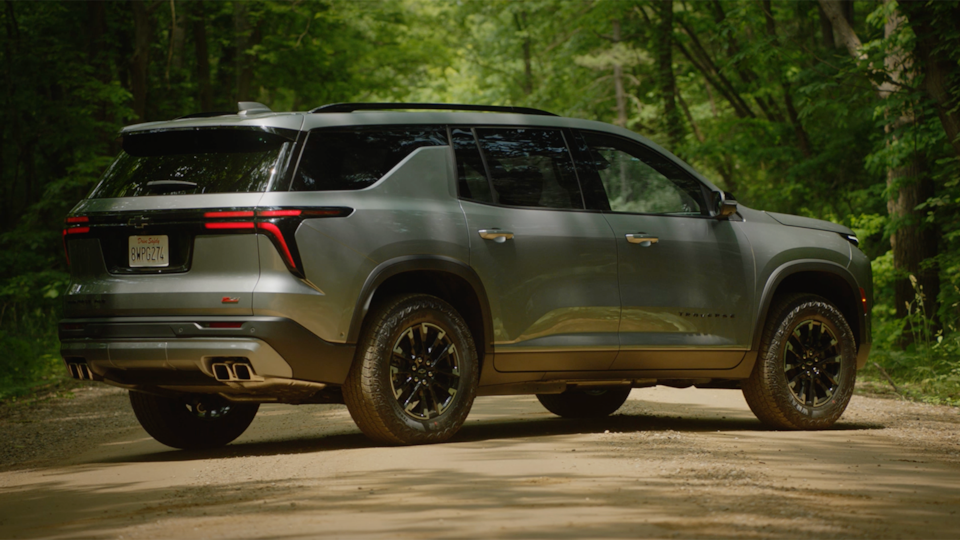 Vue latérale du VUS Chevrolet Traverse 2025 stationné seul dans une forêt.
