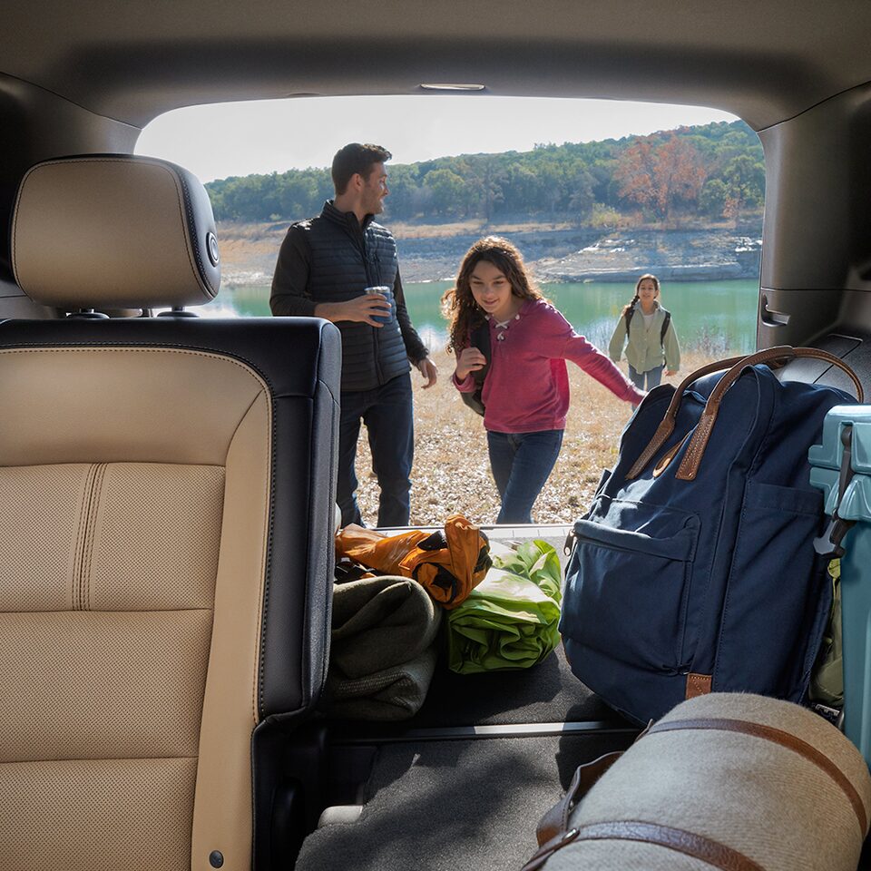 A family unpacks their camping gear from their 2024 Chevrolet Equinox.
