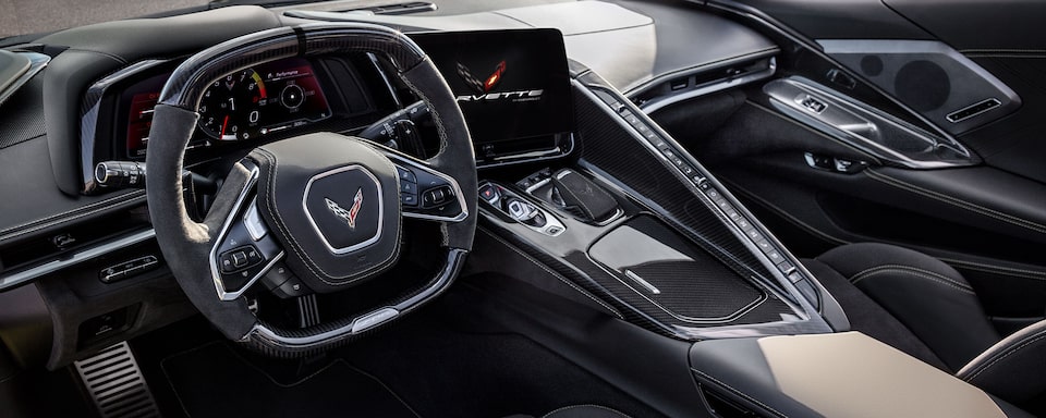 2023 Corvette Z06 front interior featuring the steering wheel, centre console and infotainment system.
