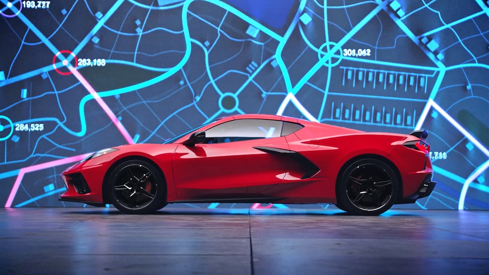 Side View of a 2025 Chevrolet Corvette Stingray with a digital map in the background.