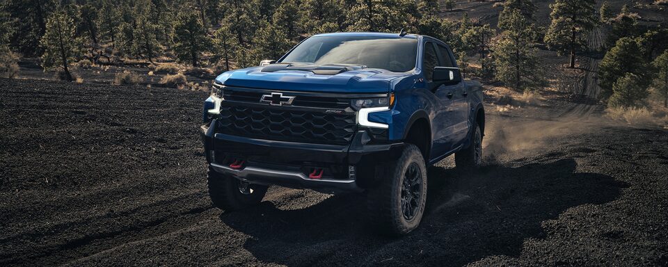Front view of the 2022 Chevrolet Silverado 1500 pickup truck driving on rough terrain.