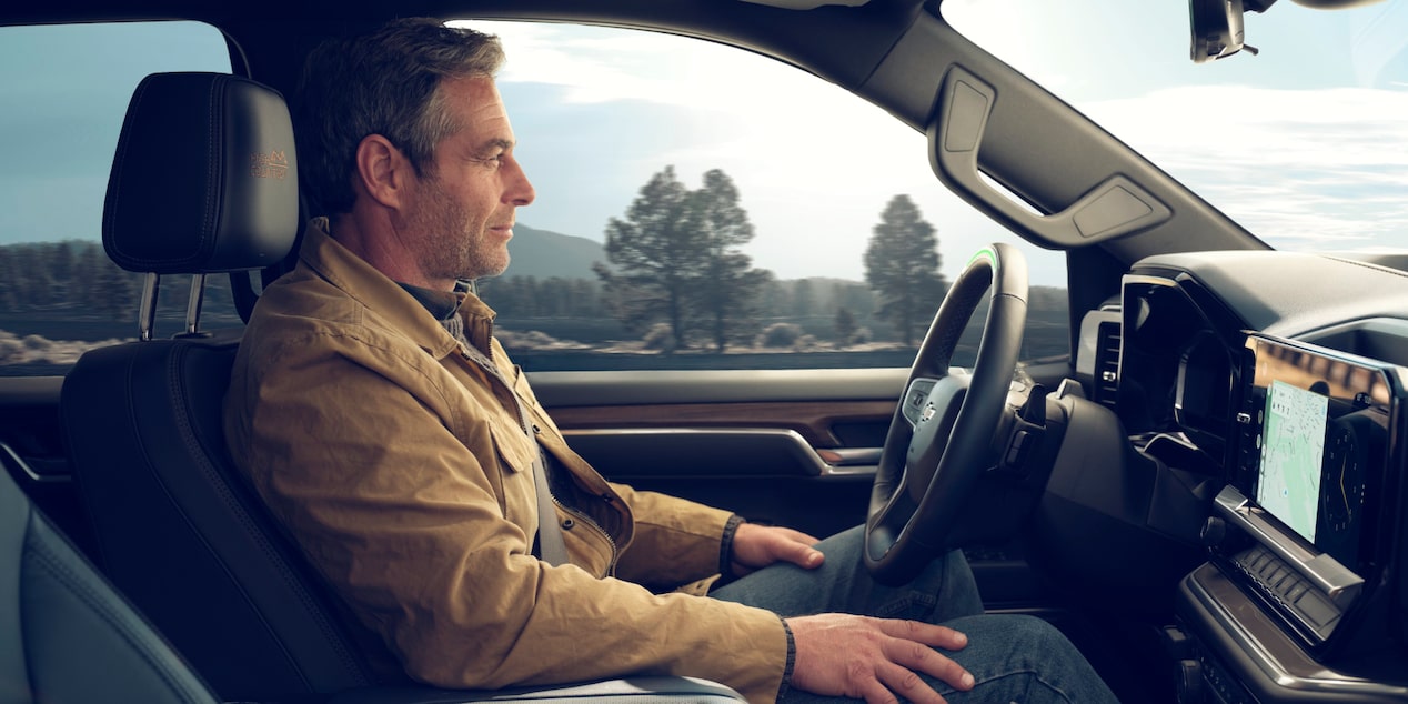 A person enjoying the Connected Services Technology of the 2025 Chevrolet Silverado LD.