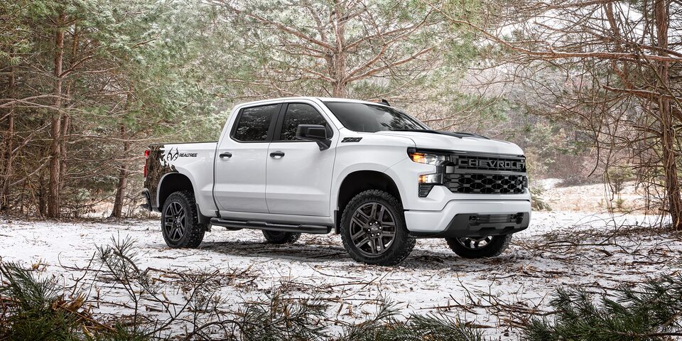 The 2024 Chevrolet Silverado Realtree Edition blending on a snowy terrain.