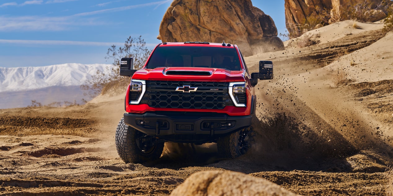Front view of a Red Chevrolet ZR2 Truck Off-roading in the Desert.