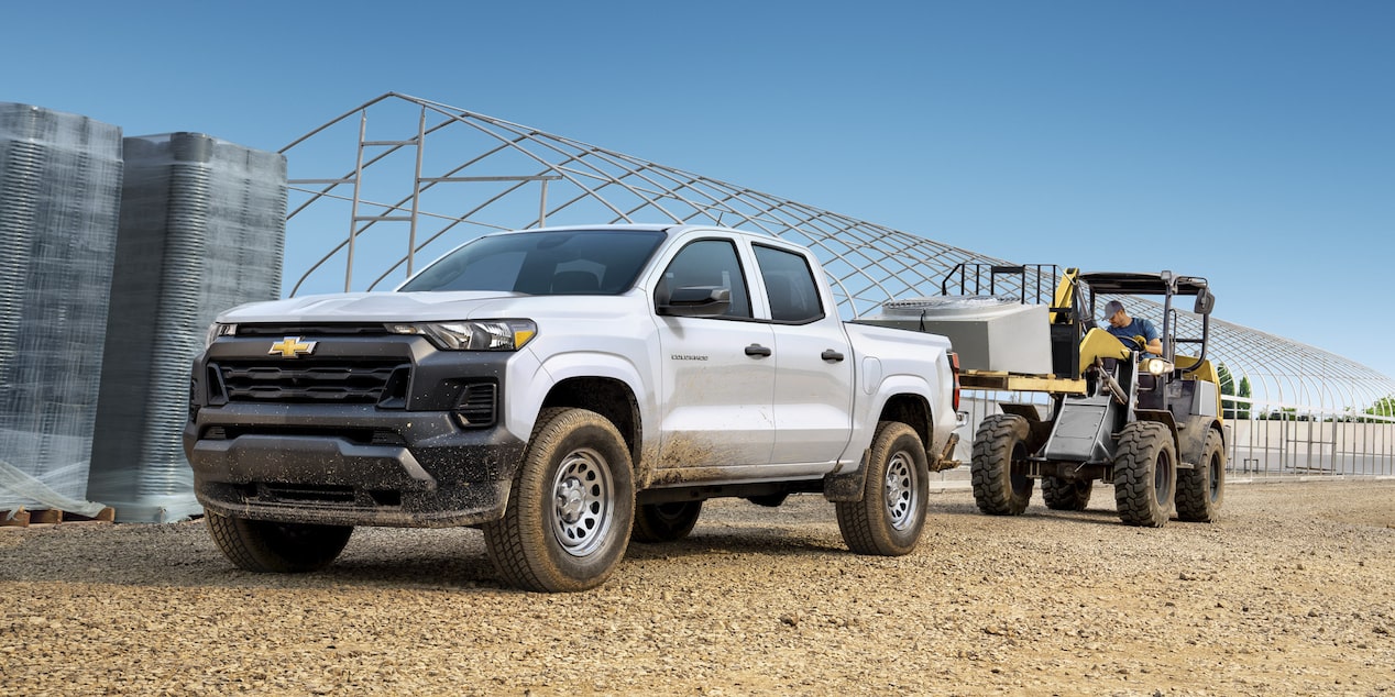 A forklift loading the bed of the 2025 Chevrolet Commercial Colorado with construction materials.