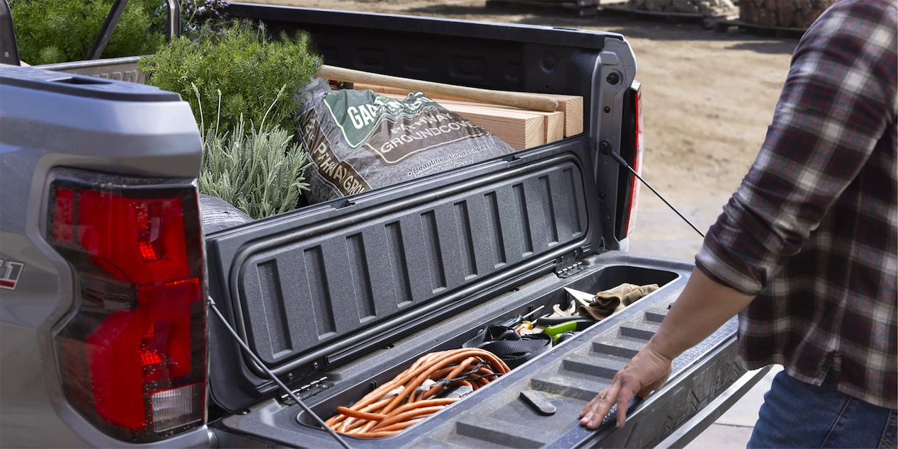 2025 Chevrolet Commercial Colorado truck bed storage compartments with landscaping tools.