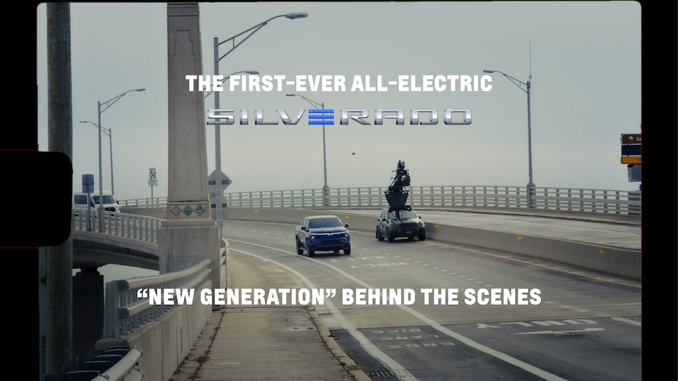 Video of the Chevrolet Silverado EV at a charging station with two men in front of it.