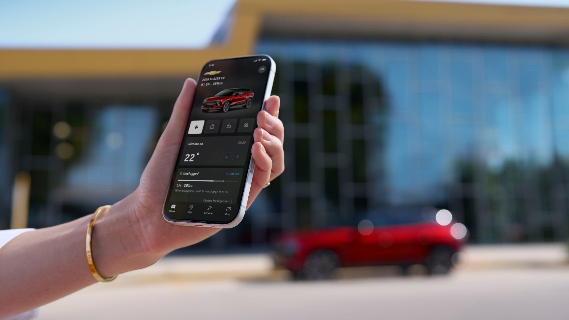 A person using a smartphone near an OnStar-subscribed Chevrolet vehicle.