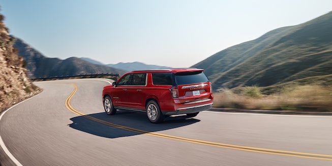 2022 Suburban Large 3-Row SUV Exterior Rear Side View Driving.