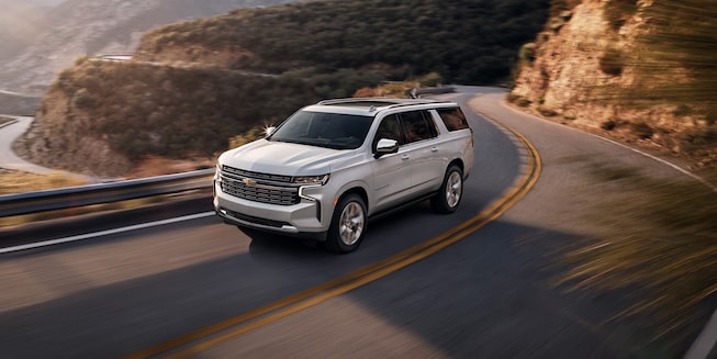 2022 Chevrolet Suburban Large 3-Row SUV Exterior Front Side View Driving.
