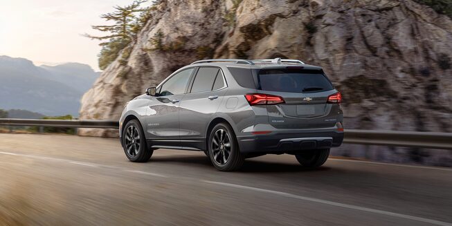 The Blue Glow Metallic 2023 Chevy Equinox Cruising on a Mountain Road