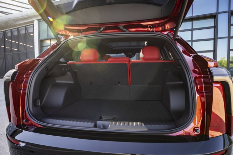 Back view of a Chevrolet Electric SUV with its trunk door open.