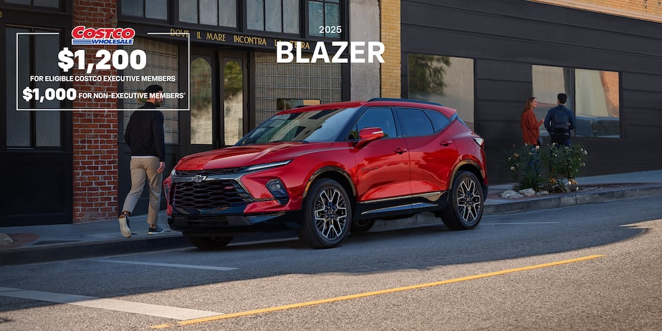 2025 Chevrolet Blazer parked beside a city building.