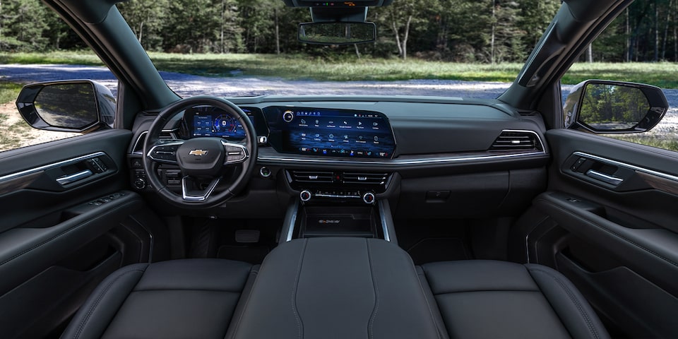 Driver's view of the Front Seats, Steering Wheel, and Infotainment System in the 2025 Chevrolet Tahoe SUV.