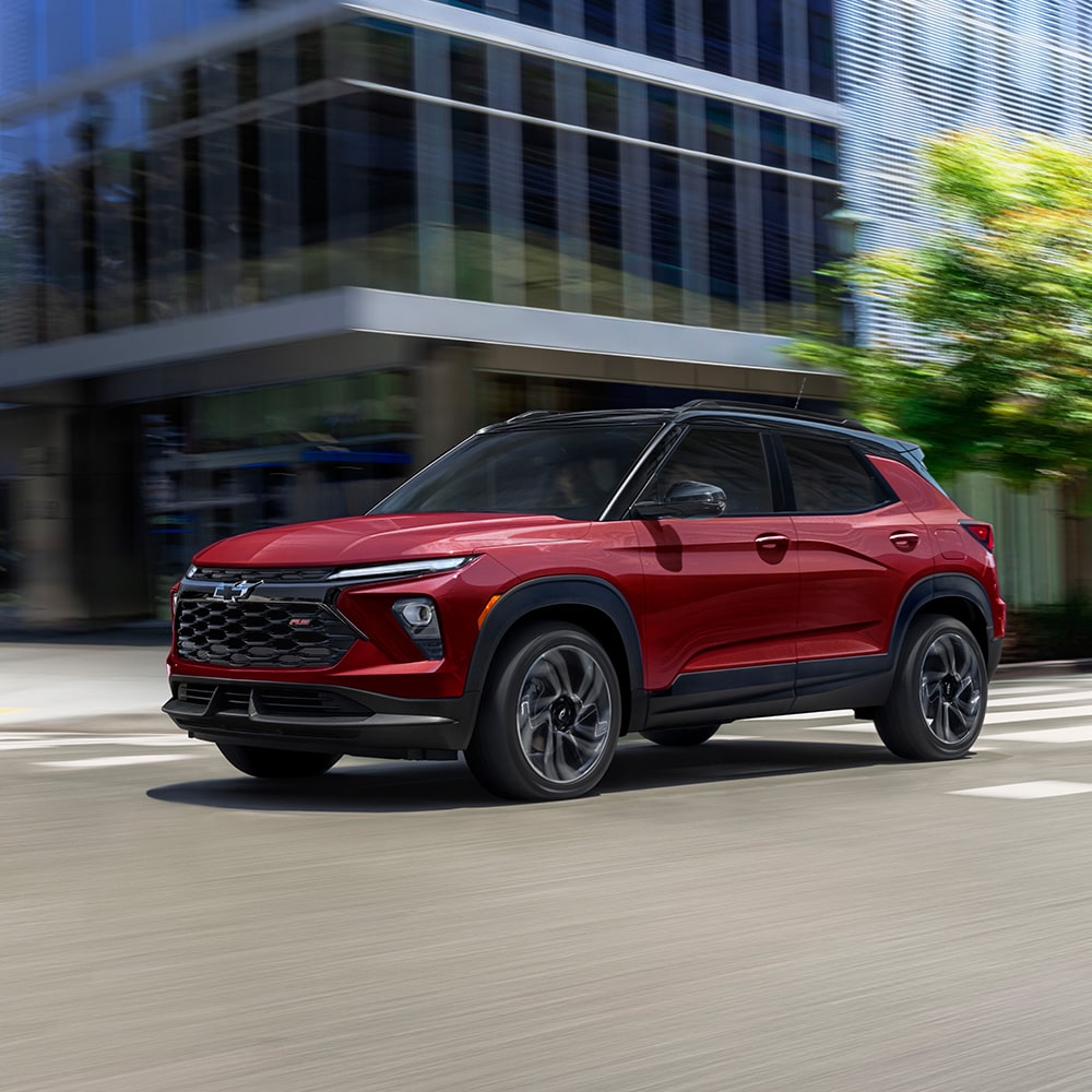 2025 Chevrolet Trailblazer driving through a city intersection.