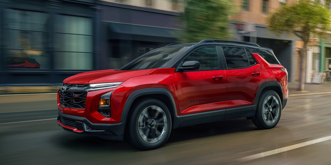 Side view of the 2026 Chevrolet Equinox driving alone in the city.