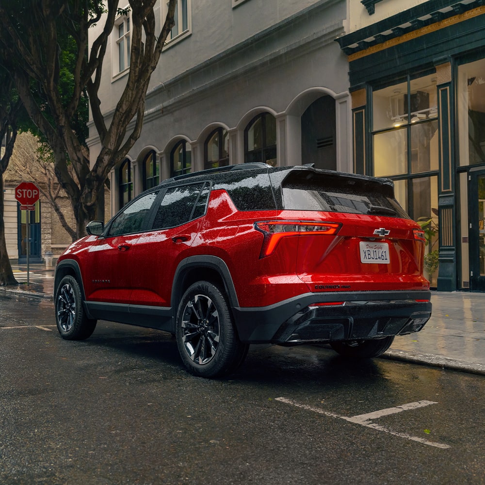 Back-side view of the 2026 Chevrolet Equinox parked by the sidewalk.