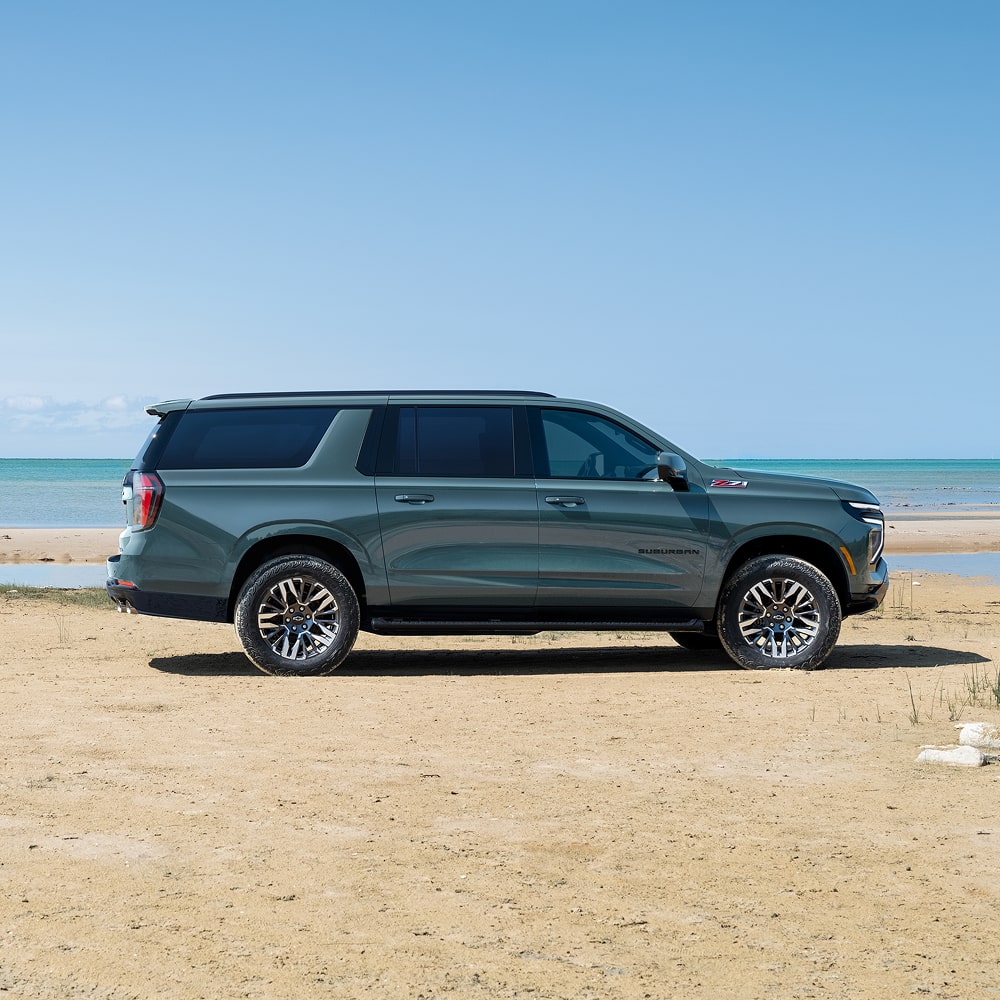 Side View of the 2026 Chevrolet Suburban SUV Parked Near a Lake.