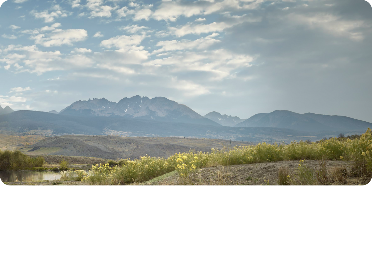 Scenic Landscape of Mountains Under a Beautiful Blue Sky.