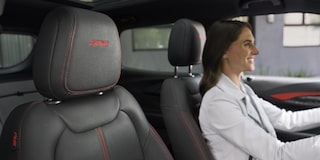 A Woman Smiling While Driving Her 2026 Chevy Trailblazer