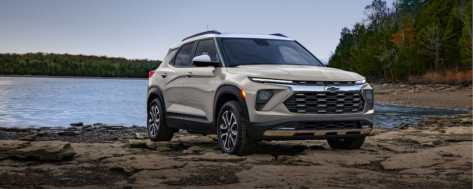 Front-side view of the 2026 Trailblazer ACTIV trim parked by a lake.