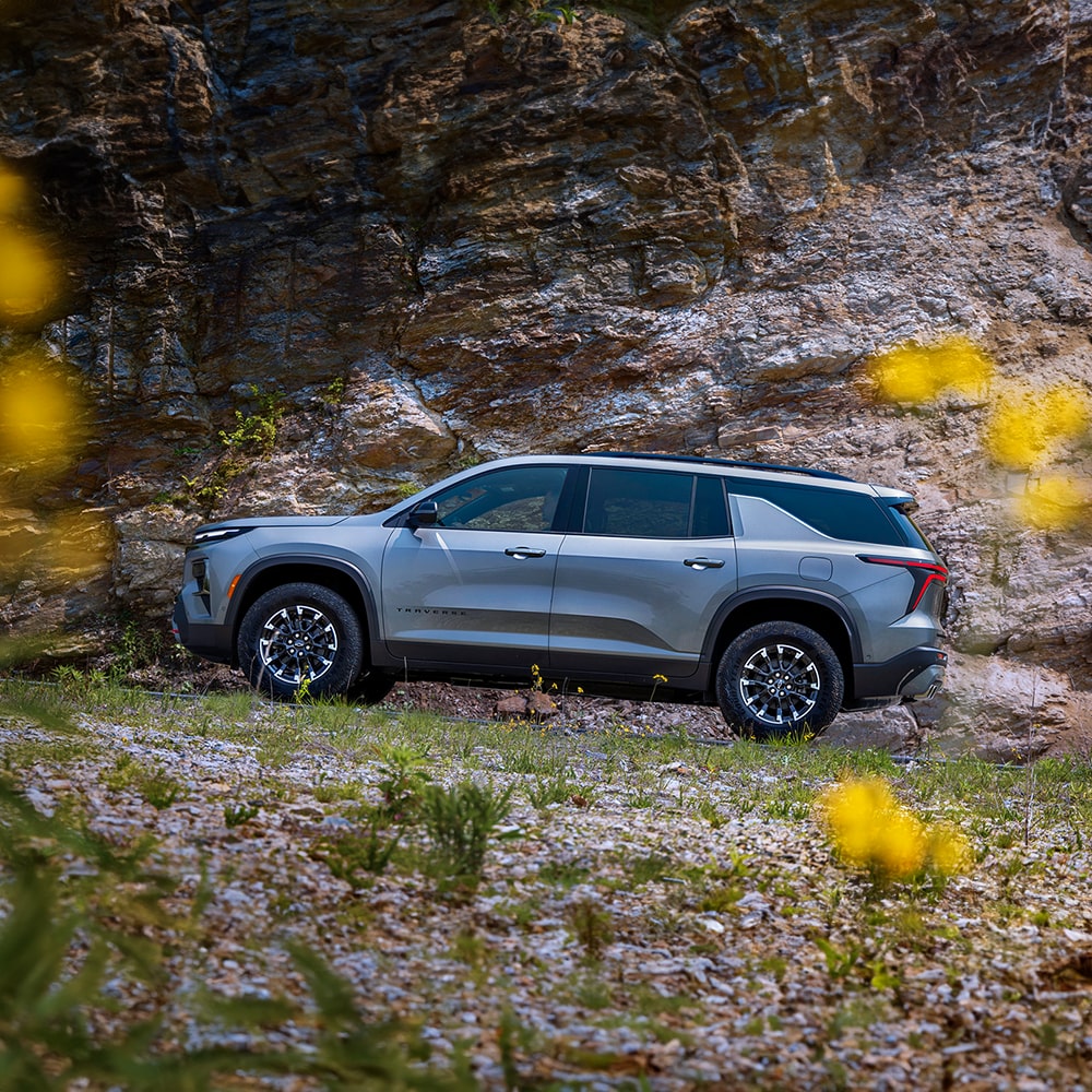 2026 Chevrolet Traverse Driving Off Road Up a Rocky Terrain.