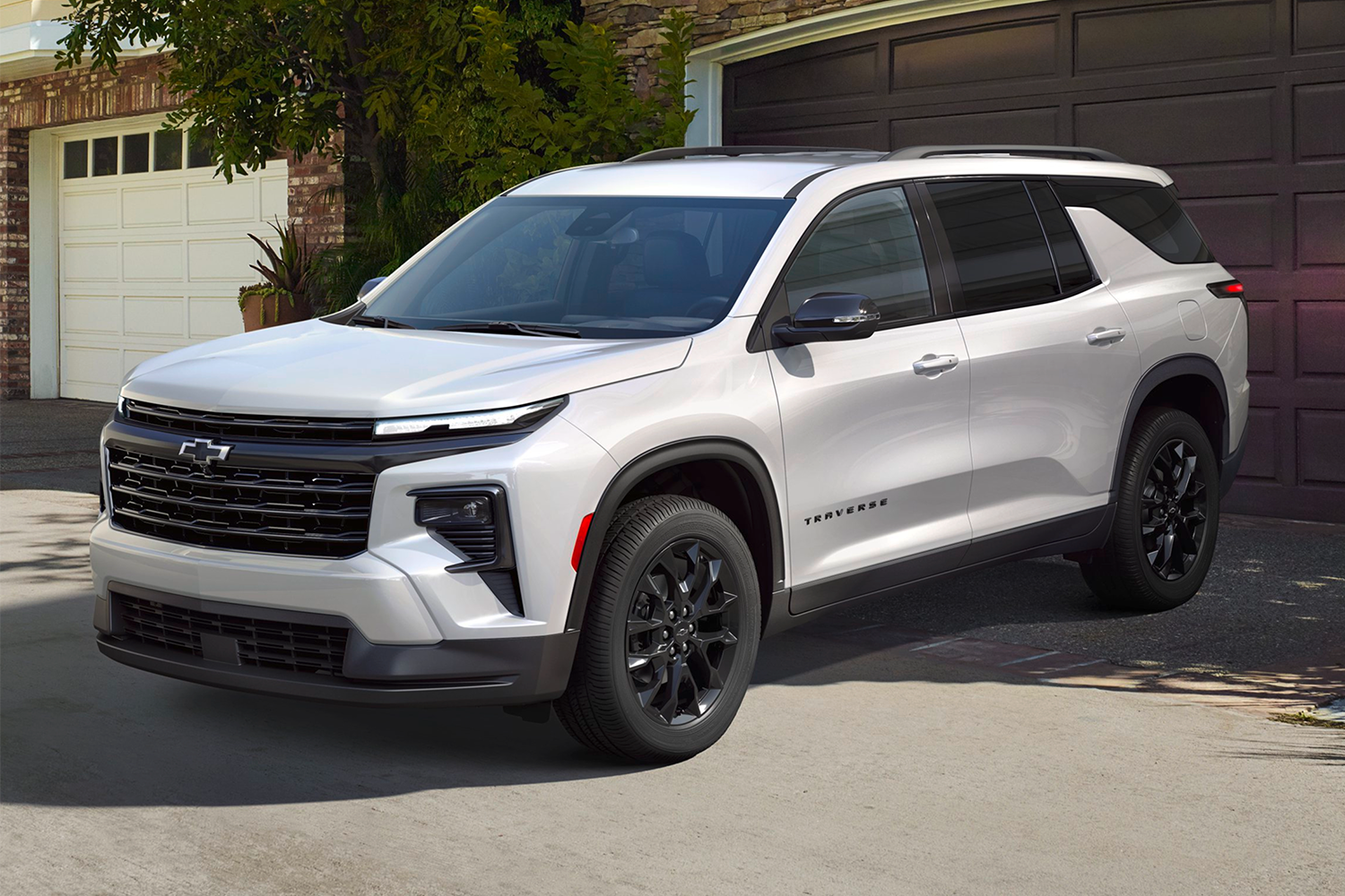 2026 Chevrolet Traverse Parked in Front of a Garage Door in a Neighborhood.