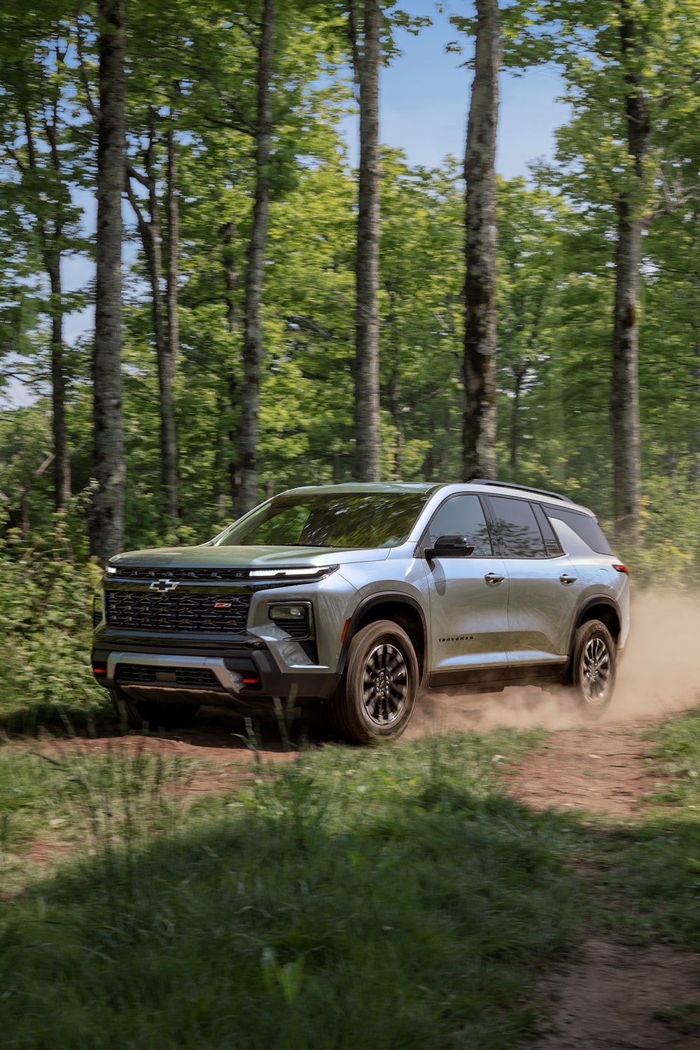 2026 Chevrolet Traverse Driving Off-Road Through the Woods.