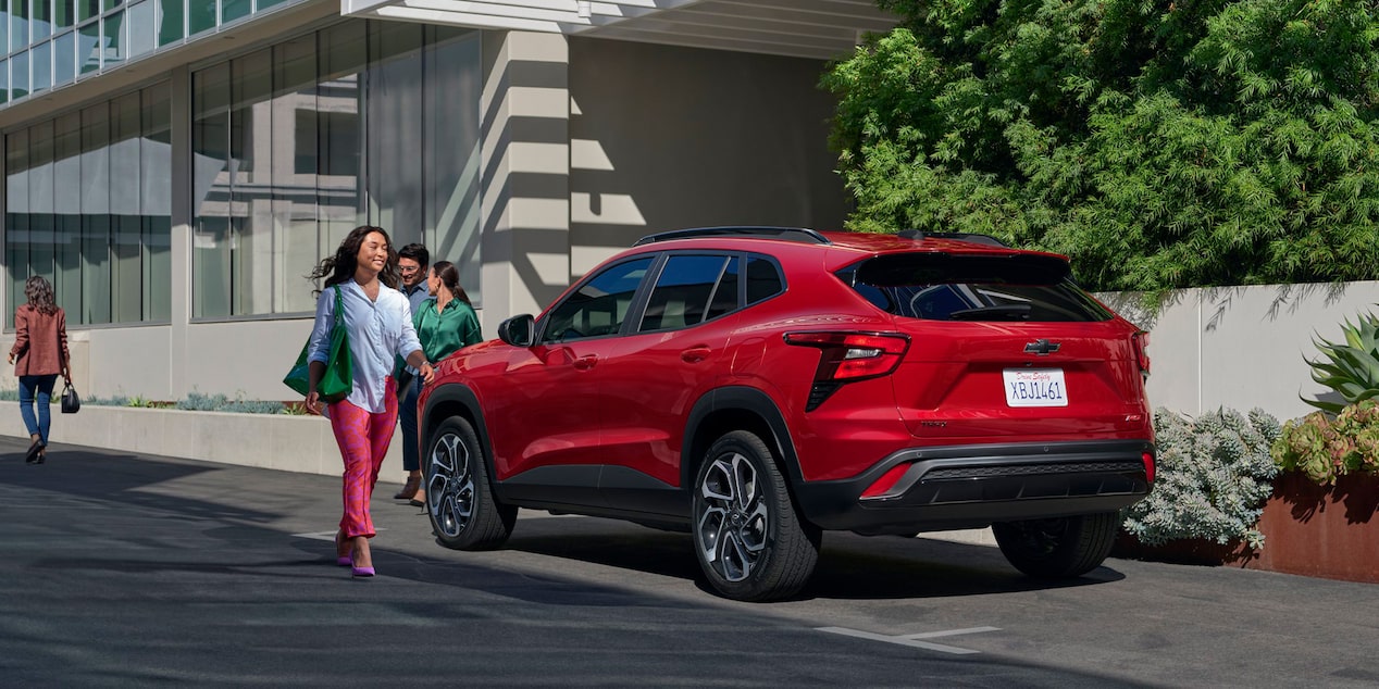 A Person Walking Toward A Parked 2026 Chevrolet Trax.