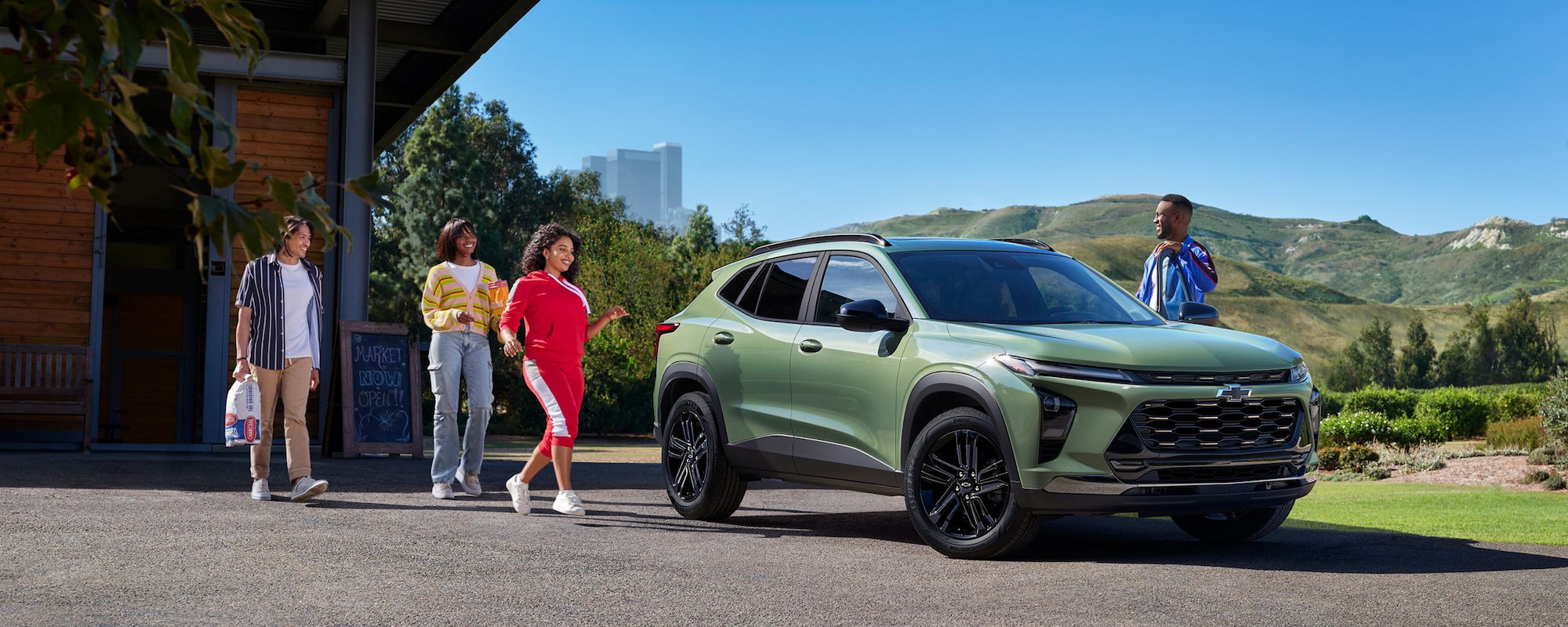 A group of people approaching the 2026 Chevrolet Trax.