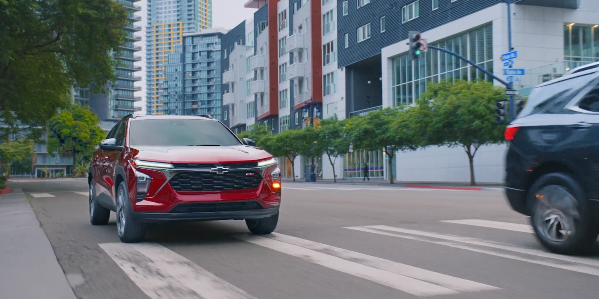 2026 Chevrolet Trax stopping at an intersection in the city.