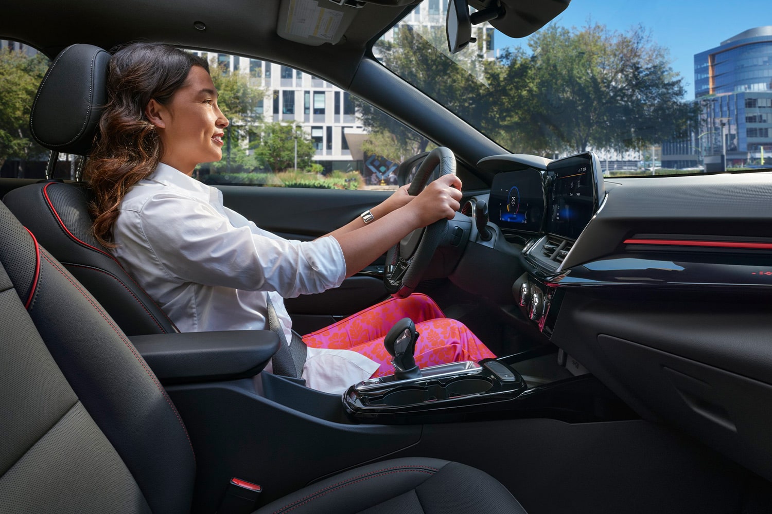 A person seated on the driver's seat of the 2026 Chevrolet Trax.