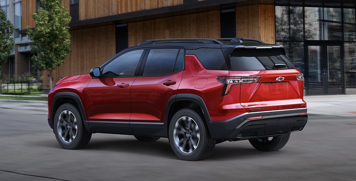 Side view of the 2027 Chevrolet Equinox parked near a building.