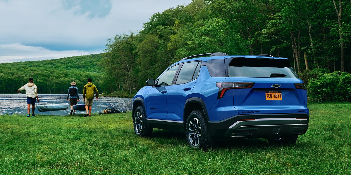 2027 Chevrolet Equinox parked near a forest on a sunny day.