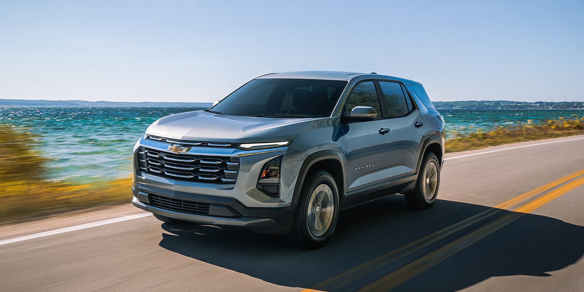 Three-quarters View of a Chevrolet Equinox Driving Down a Road Outlooking the Ocean