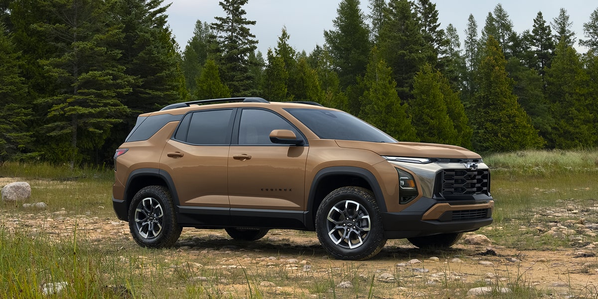 Profile View of a 2027 Chevrolet Equinox Parked in the Middle of an Open Area in the Woods