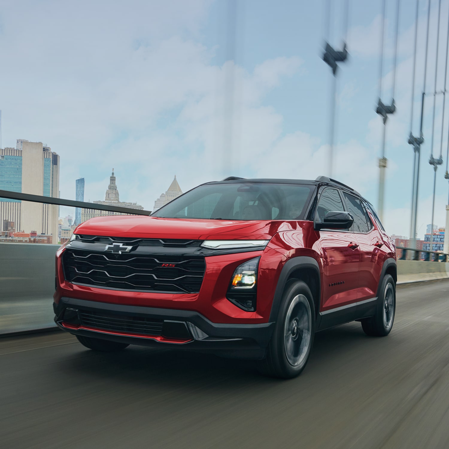 2027 Chevrolet Equinox driving alone on a city bridge.