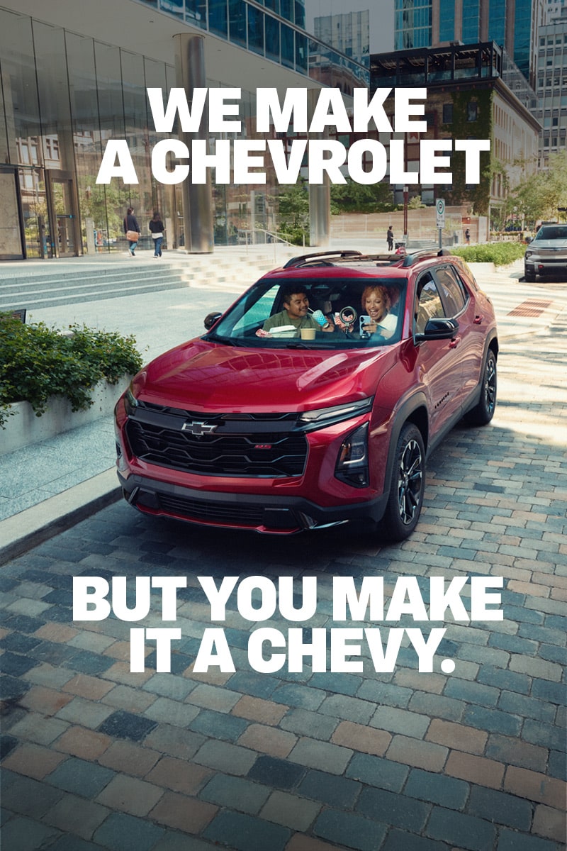 2027 Chevrolet Equinox driving alone on a city bridge.
