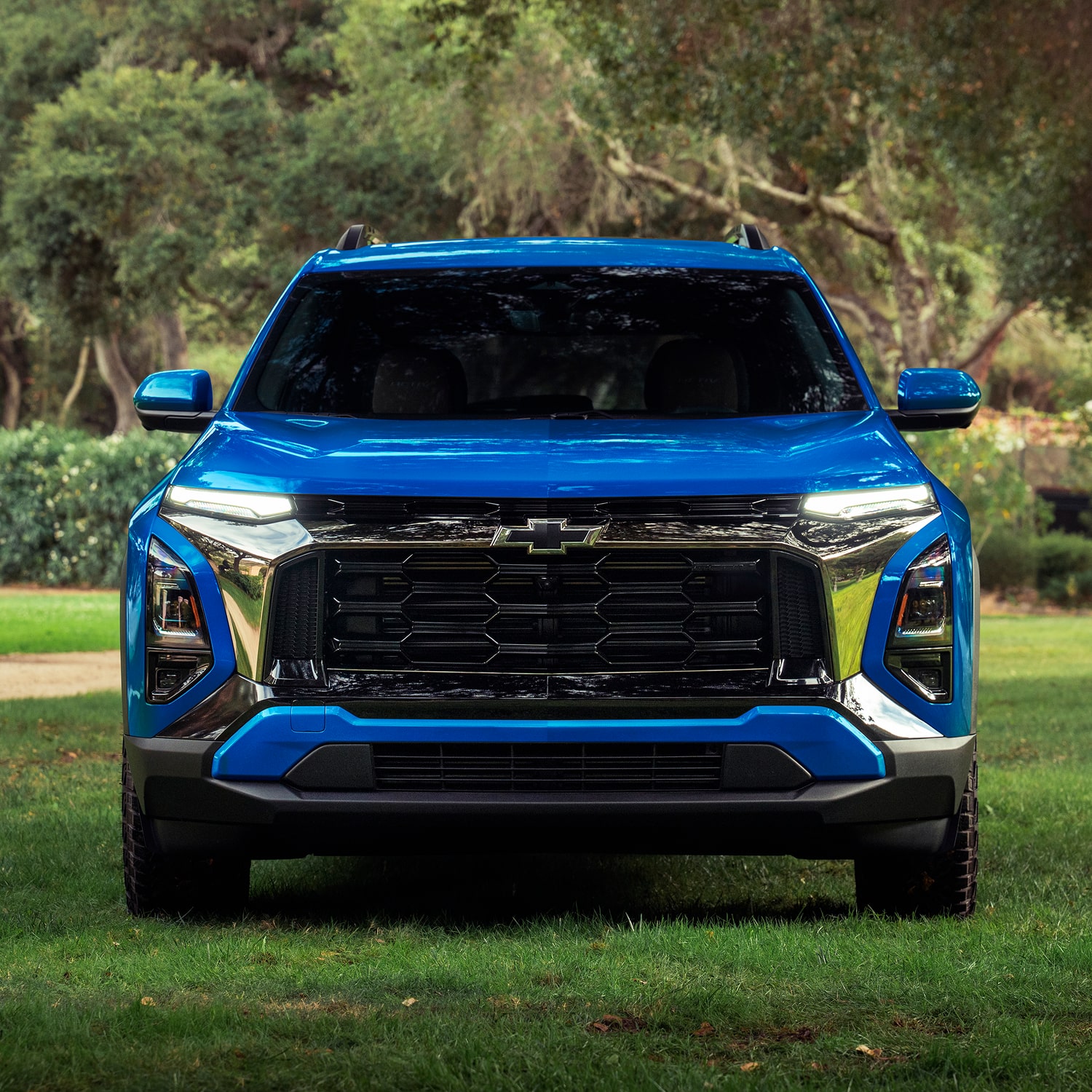 Front view of the 2027 Chevrolet Equinox parked on a grassy terrain.