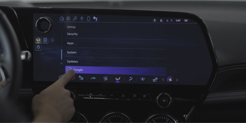 A person pressing the infotainment screen inside the Chevrolet Blazer EV.