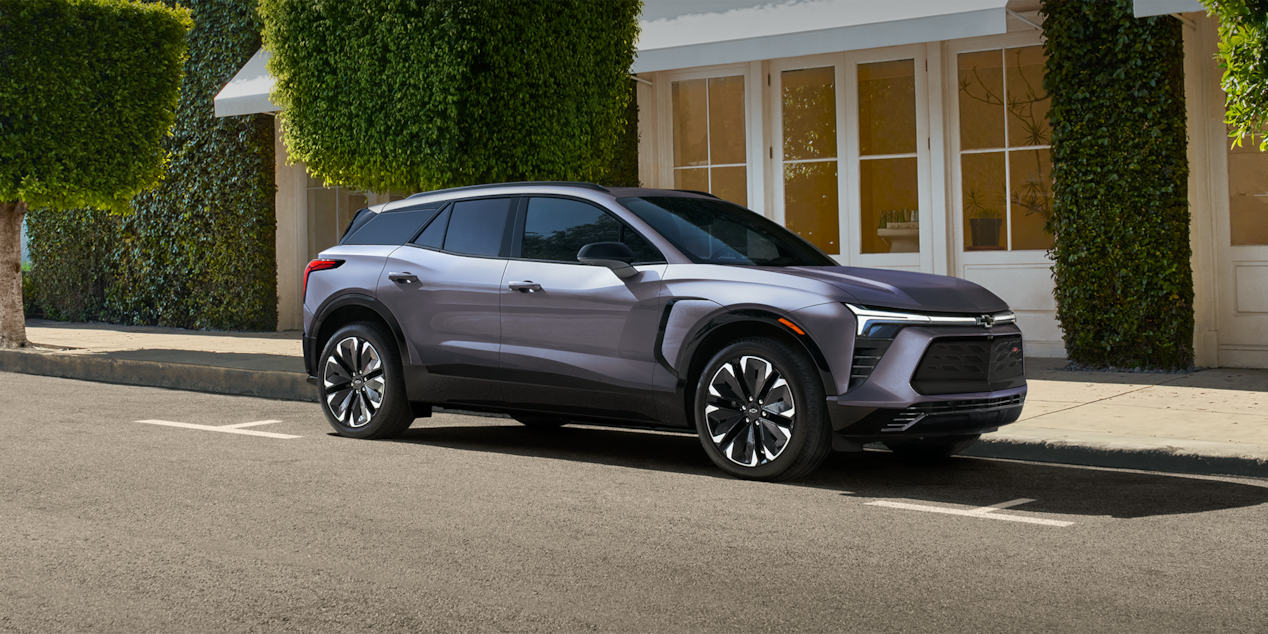 Side view of the 2026 Chevrolet Blazer EV parked near a lake.