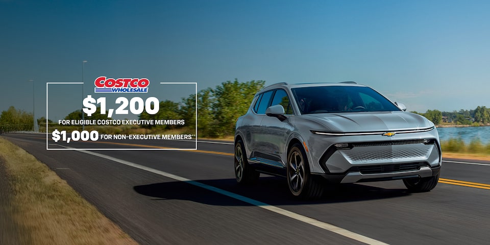Front-side view of a 2025 Chevrolet Equinox EV driving down the road.