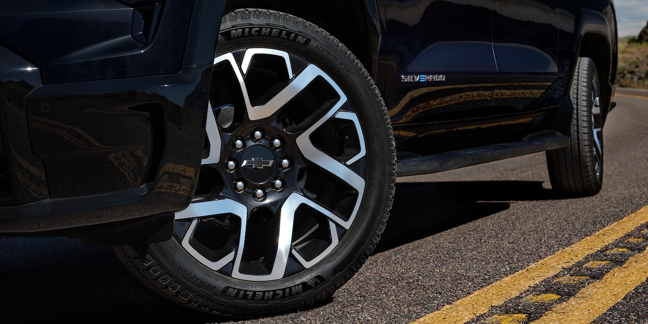 Low angle view of the tires of a 2025 Chevrolet Silverado EV on a road.