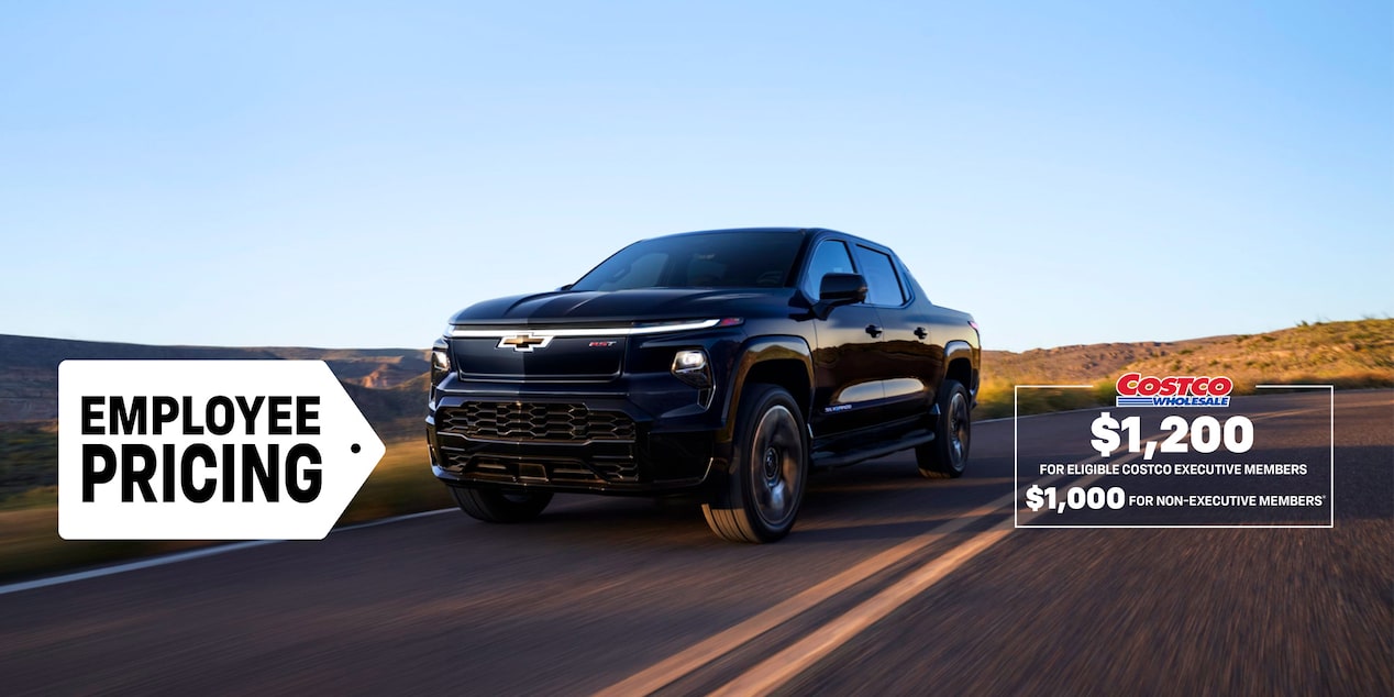 Front-side view of a 2025 Chevrolet Silverado EV driving down the road.