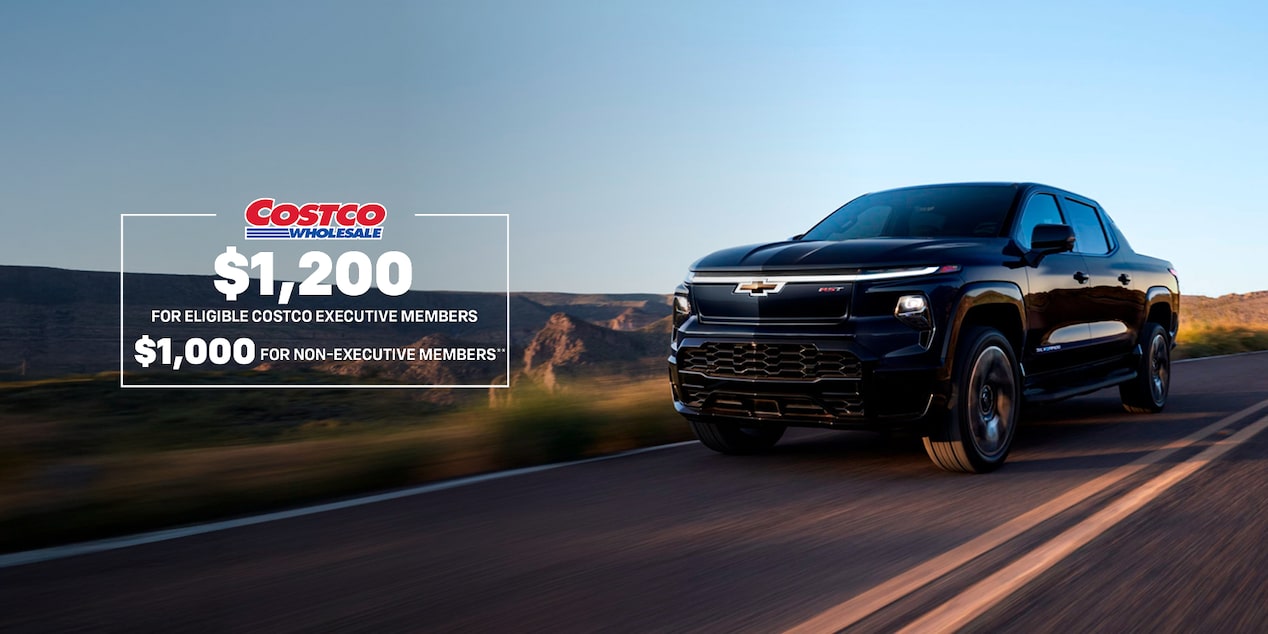 Front-side view of a 2025 Chevrolet Silverado EV driving down the road.